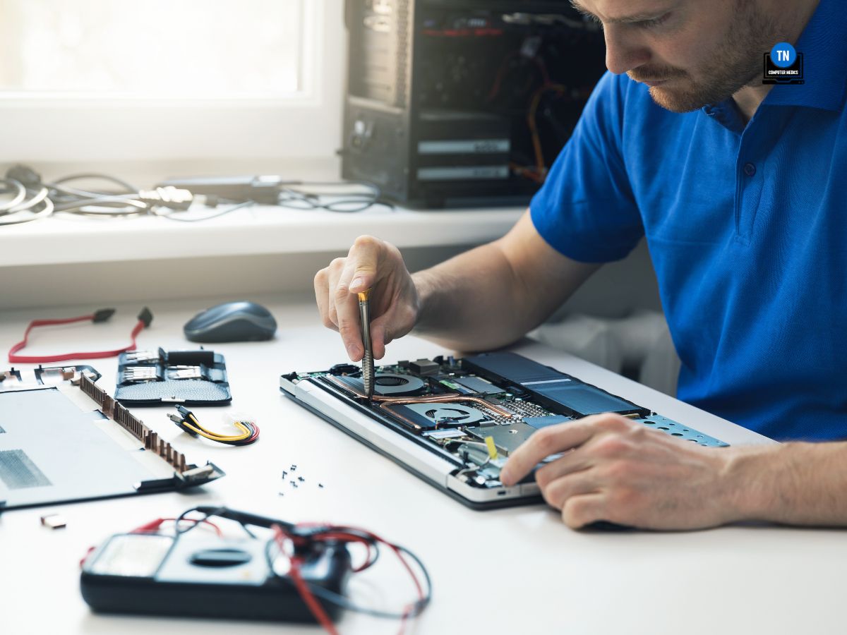 computer repair service - technician repairing broken laptop in office - PC Repair Murfreesboro